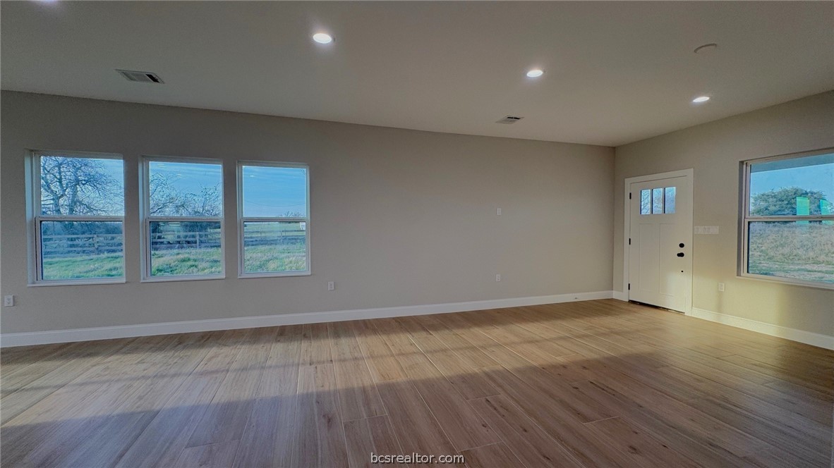 3917 Harbor Bolton Road Franklin, TX 77856 - Photo 7 of 26 an empty room with wooden floor and windows