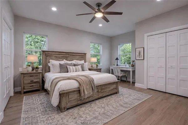a spacious bedroom with a bed and a window