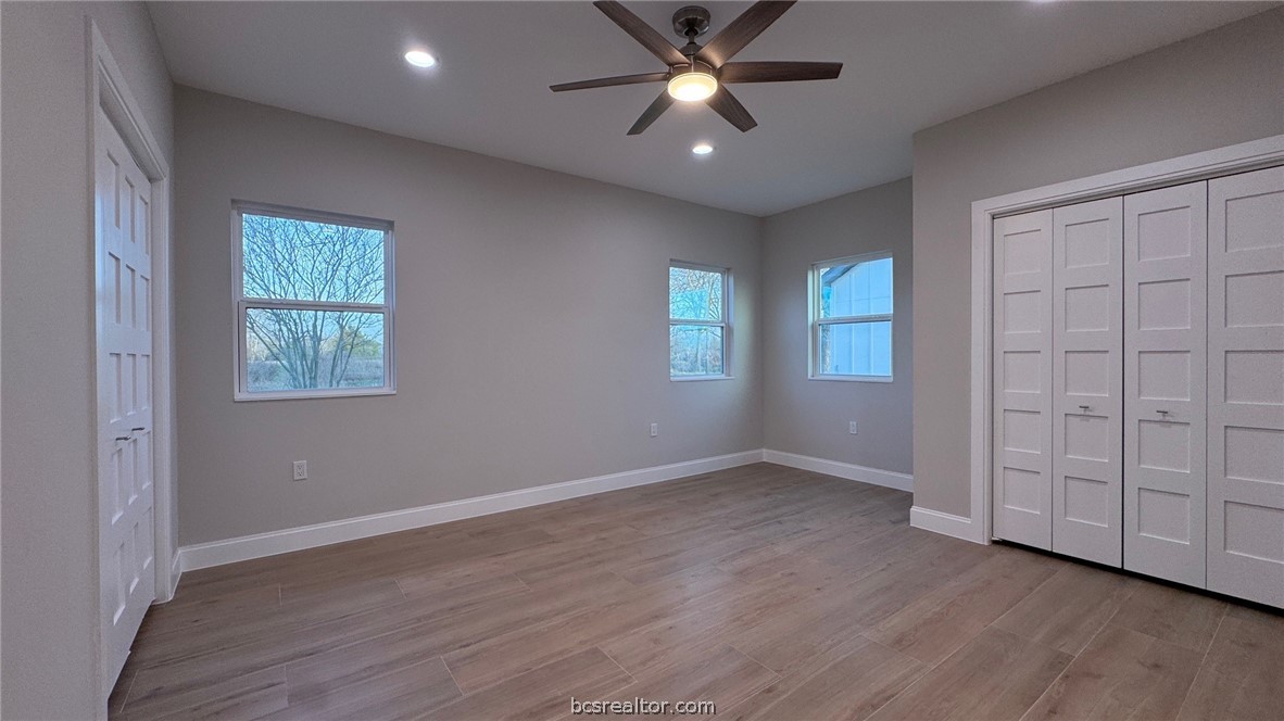 3917 Harbor Bolton Road Franklin, TX 77856 - Photo 9 of 26 an empty room with wooden floor closet and windows