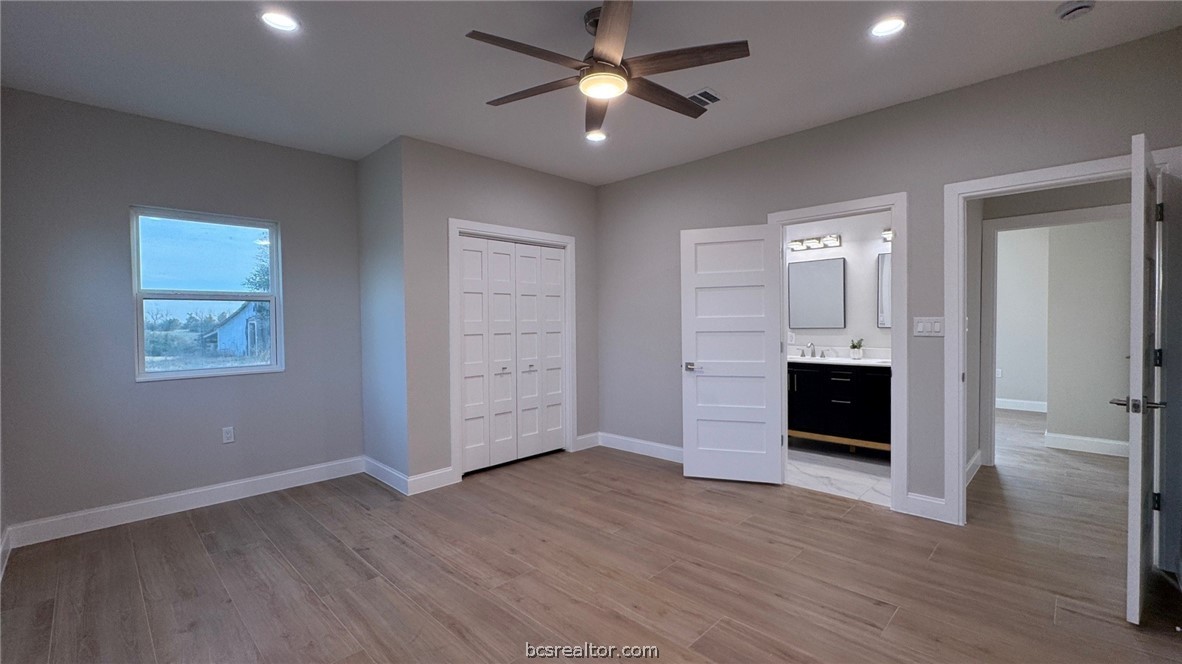 3917 Harbor Bolton Road Franklin, TX 77856 - Photo 10 of 26 wooden floor in an empty room with a window