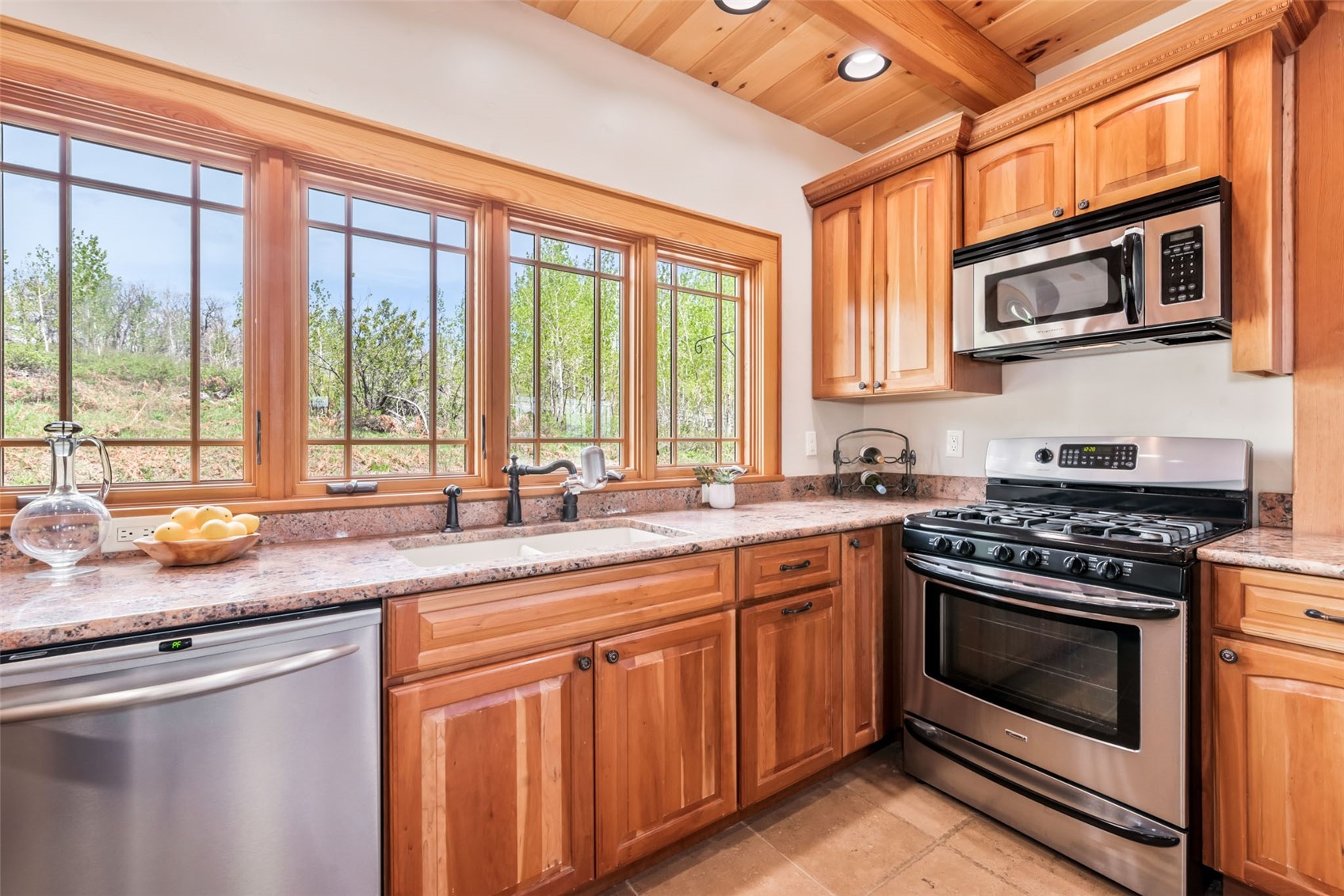51193 Smith Creek Road Steamboat Springs, CO 80487 - Photo 17 of 48 a kitchen with stainless steel appliances granite countertop a stove and a microwave