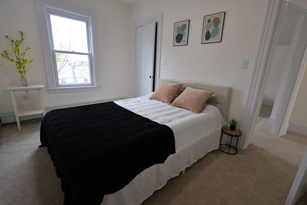 331 Proctor Avenue Revere, MA 02151 - Photo 18 of 29 a bedroom with a bed and a window