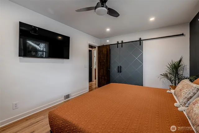 a bedroom with a bed and a flat screen tv