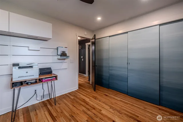 a kitchen with stainless steel appliances a refrigerator and a wooden floor