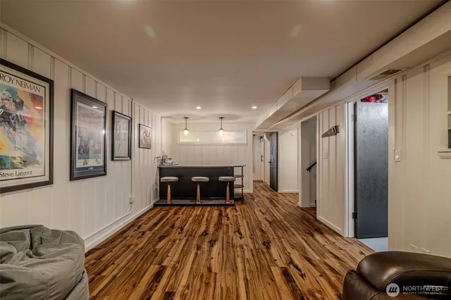 a spacious bedroom with a bed and wooden floor
