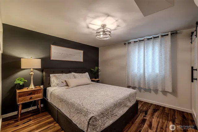 a bedroom with a bed and a window