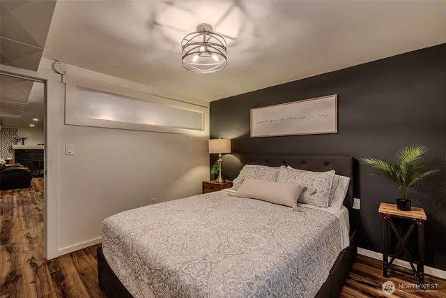 a bedroom with a bed and a chandelier