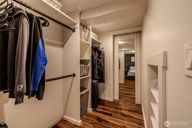 a view of walk in closet with clothes and shoes