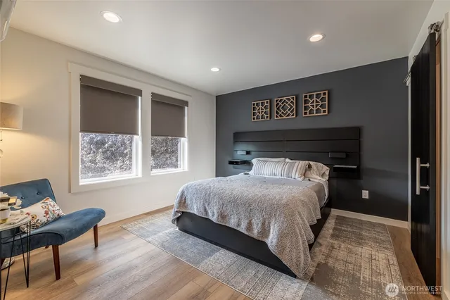 a bedroom with a bed and a window