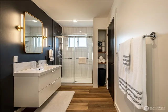 a bathroom with a sink a mirror and a shower