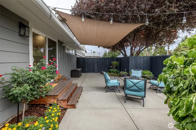 a view of house with backyard and sitting area