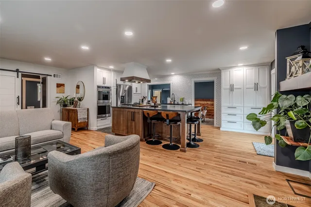 a living room with furniture and a wooden floor