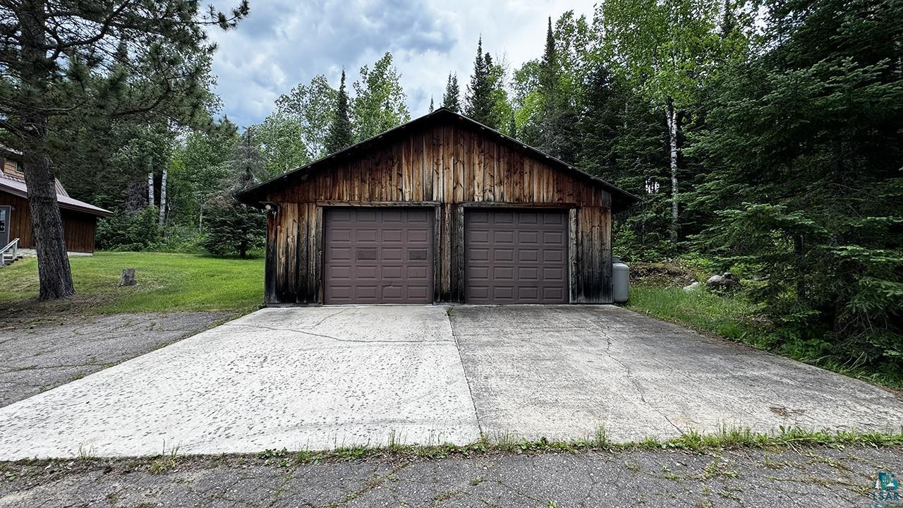 9289 Heino Road Angora, MN 55703 - Photo 27 of 37 Two-car detached garage featuring natural wood siding and a gabled roofline