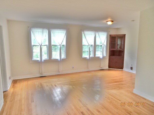 1805 Gilbert Avenue Downers Grove, IL 60515 - Photo 4 of 15 an empty room with wooden floor and windows