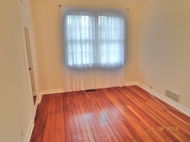 1805 Gilbert Avenue Downers Grove, IL 60515 - Photo 5 of 15 an empty room with wooden floor and windows