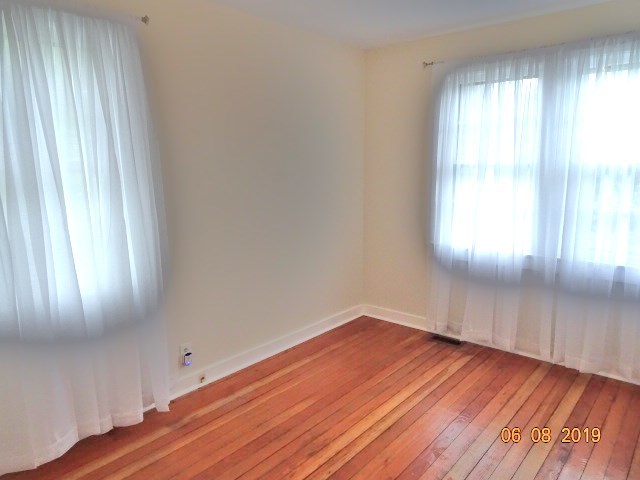 1805 Gilbert Avenue Downers Grove, IL 60515 - Photo 6 of 15 an empty room with wooden floor and windows