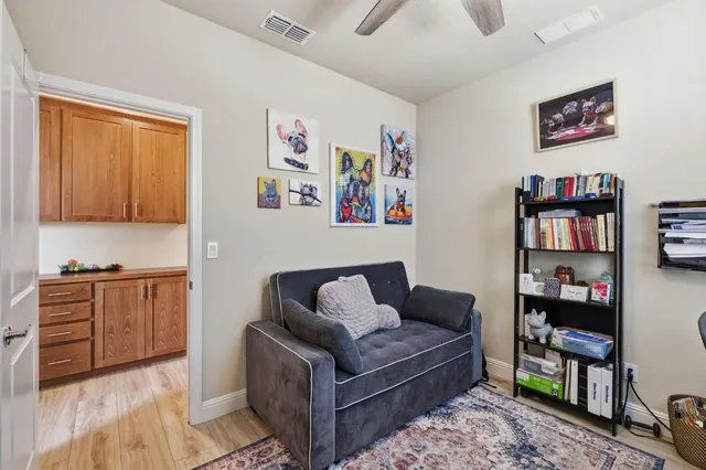 a living room with furniture and a bookshelf
