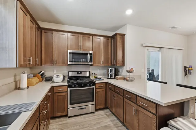 a kitchen with a sink stove top oven and refrigerator