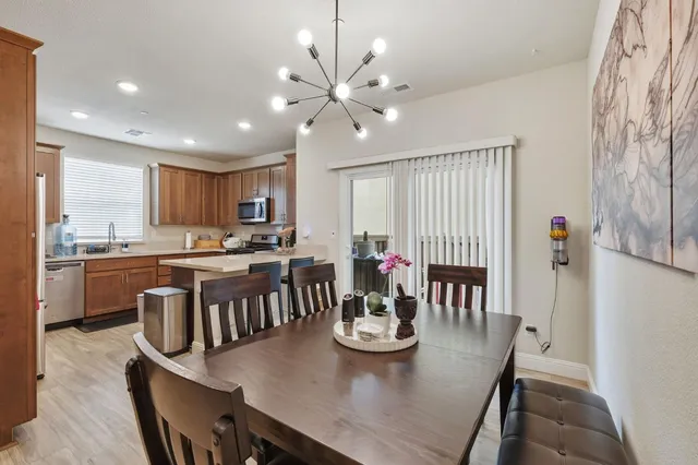 a view of a dining room with furniture and a kitchen