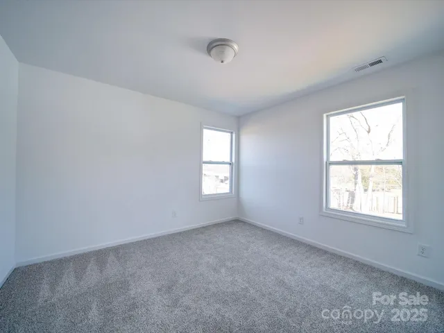 a view of an empty room and a window