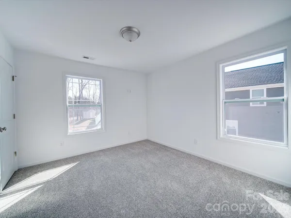 a view of an empty room and a window