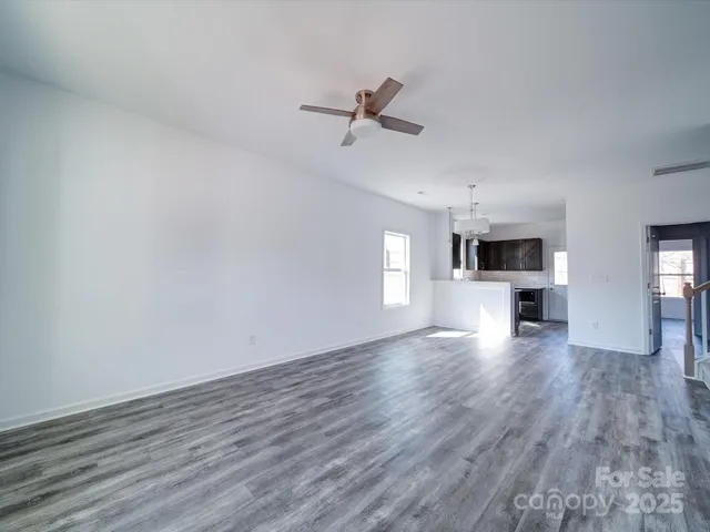 a view of a kitchen with a dishwasher and wooden floor