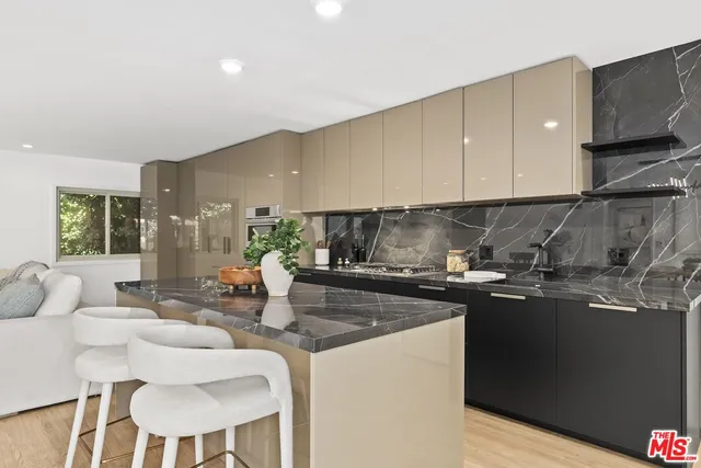 a kitchen with stainless steel appliances granite countertop a sink and a stove