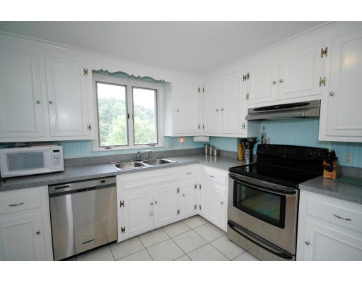 44 Chestnut Hill Road Groton, MA 01450 - Photo 16 of 23 a kitchen with granite countertop white cabinets and appliances