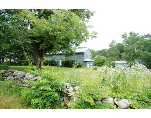 44 Chestnut Hill Road Groton, MA 01450 - Photo 2 of 23 a view of a house with a backyard and a garden