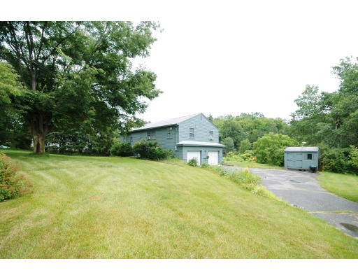 44 Chestnut Hill Road Groton, MA 01450 - Photo 4 of 23 a view of a house with a yard and garage