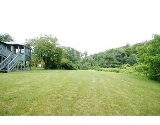 44 Chestnut Hill Road Groton, MA 01450 - Photo 7 of 23 a view of a big yard with an outdoor space
