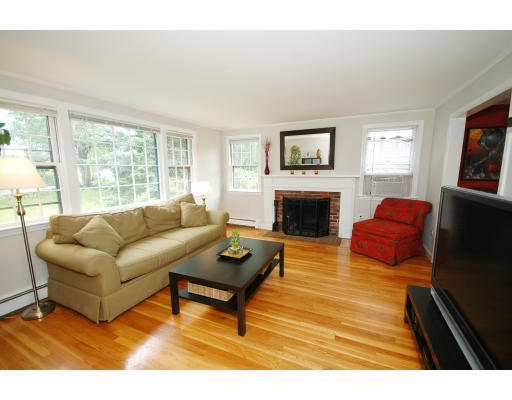 44 Chestnut Hill Road Groton, MA 01450 - Photo 9 of 23 a living room with furniture a flat screen tv and a fireplace