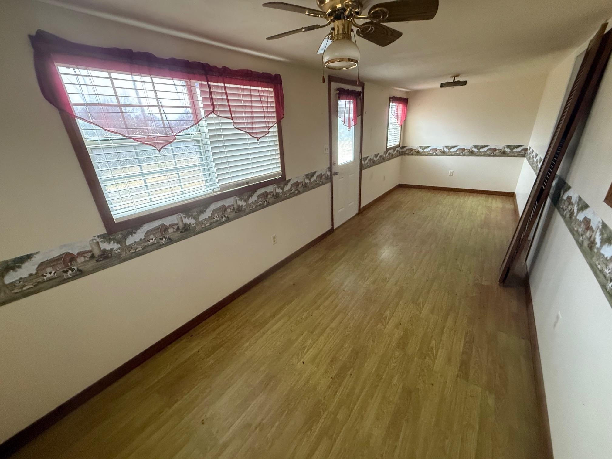 465 Hinkle Road South Sardis, TN 38371 - Photo 8 of 39 Spare room with ceiling fan, plenty of natural light, and hardwood / wood-style floors