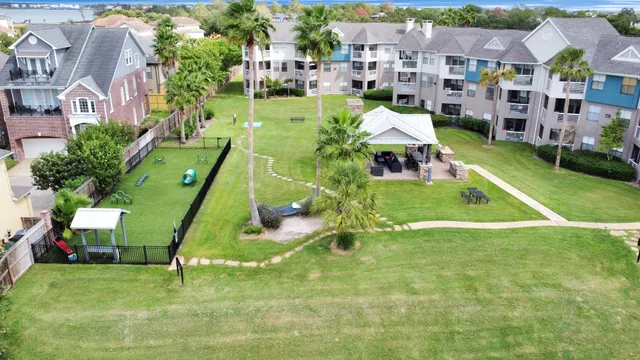 an aerial view of residential houses with outdoor space and street view