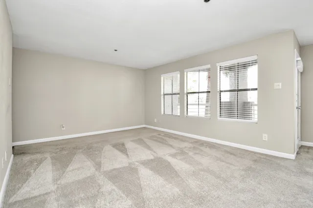a view of kitchen with cabinets and refrigerator