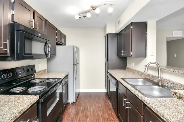 a bathroom with a granite countertop sink and mirror