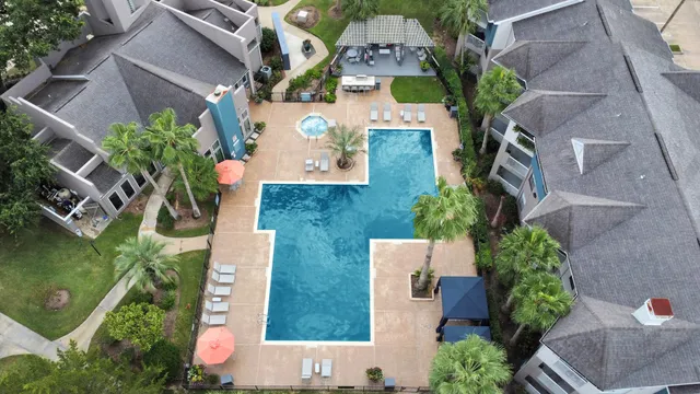 a view of a patio with couches plants and a fireplace