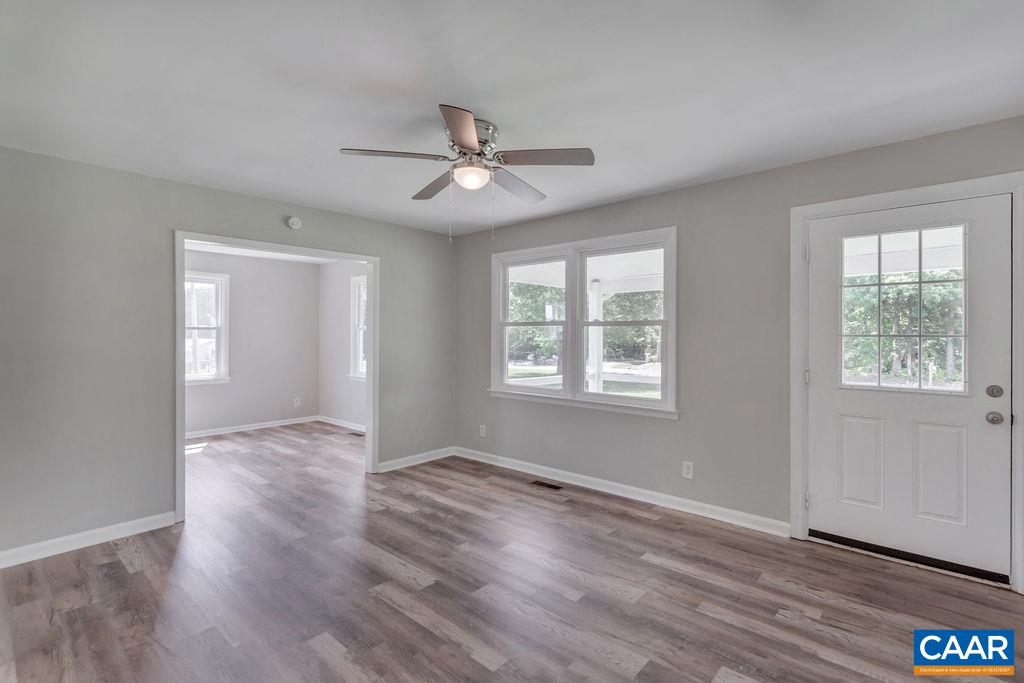 8087 Chestnut Grove Road Esmont, VA 22937 - Photo 15 of 36 a view of an empty room with wooden floor and a window