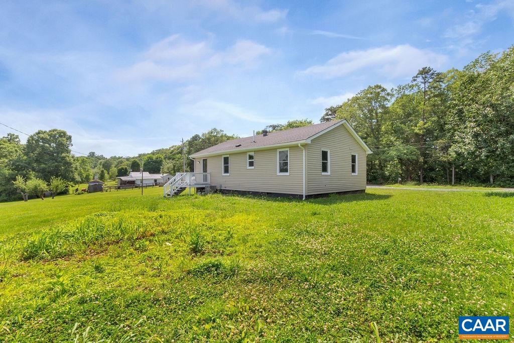 8087 Chestnut Grove Road Esmont, VA 22937 - Photo 8 of 36 a view of a house with a backyard