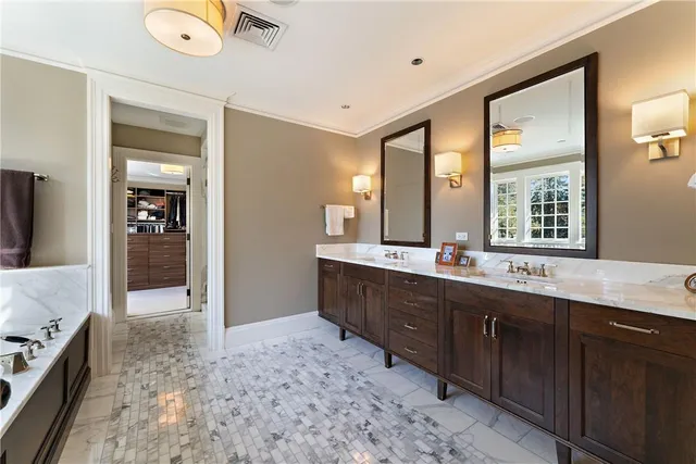 a large bathroom with a large tub sink and mirror