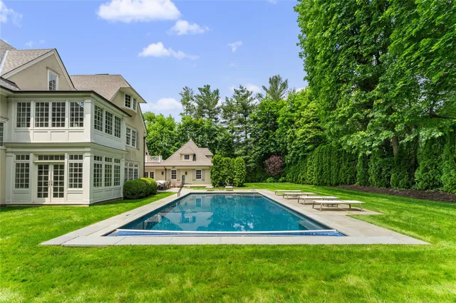 an aerial view of a house with swimming pool and outdoor space