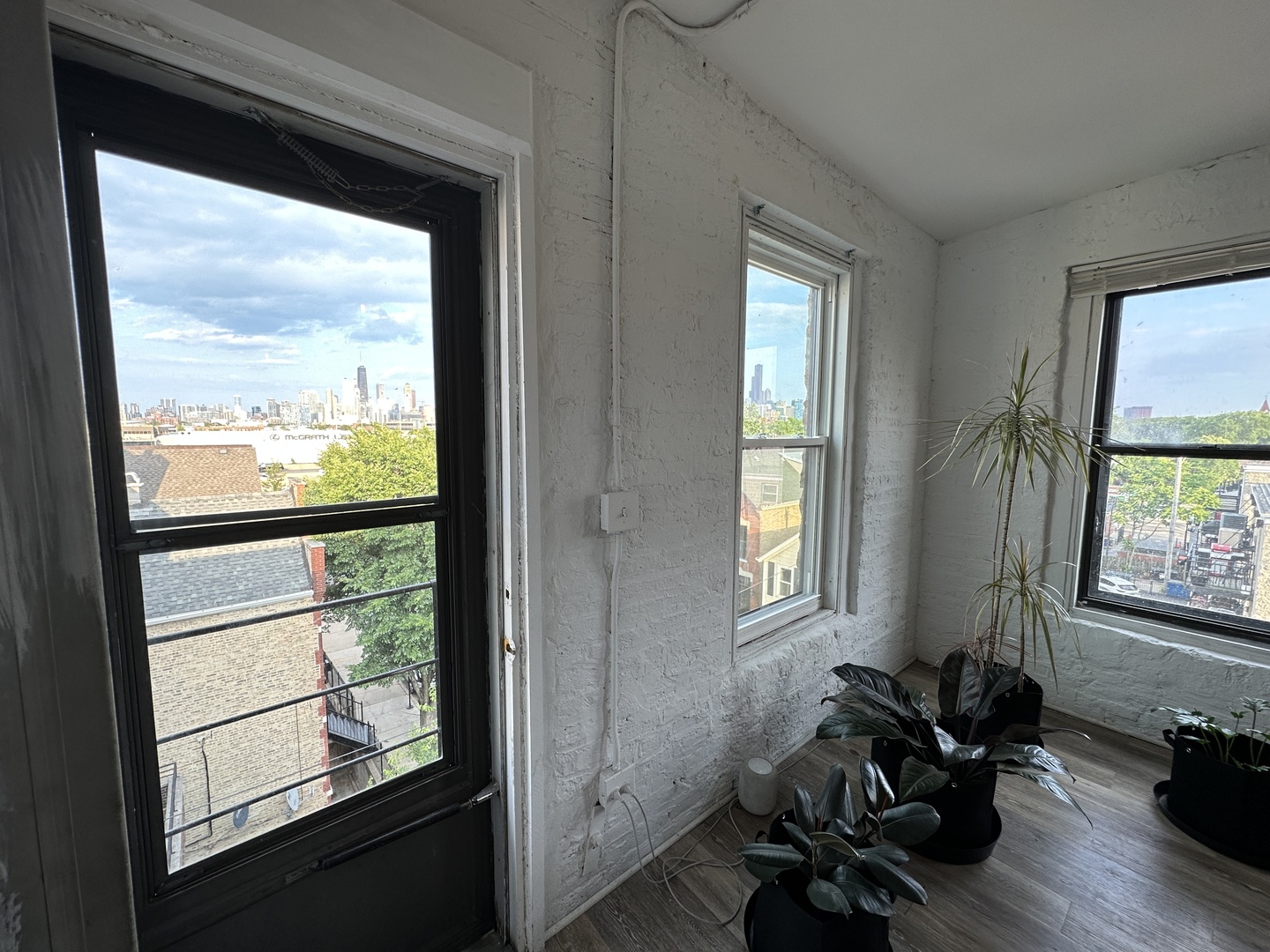 1237 North Noble Street, Unit 4 Chicago, IL 60642 - Photo 12 of 27 a room with wooden floor and windows