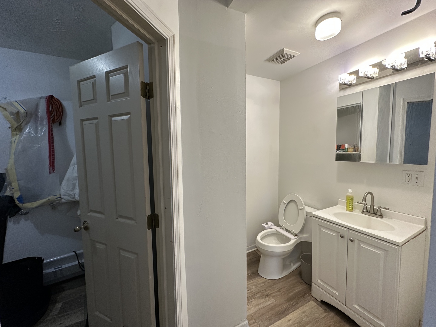 1237 North Noble Street, Unit 4 Chicago, IL 60642 - Photo 17 of 27 a bathroom with a toilet sink and mirror