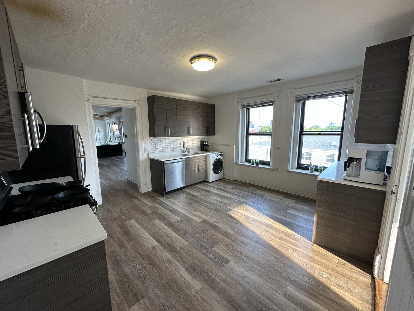 1237 North Noble Street, Unit 4 Chicago, IL 60642 - Photo 22 of 27 a living room with fireplace furniture flat screen tv and windows