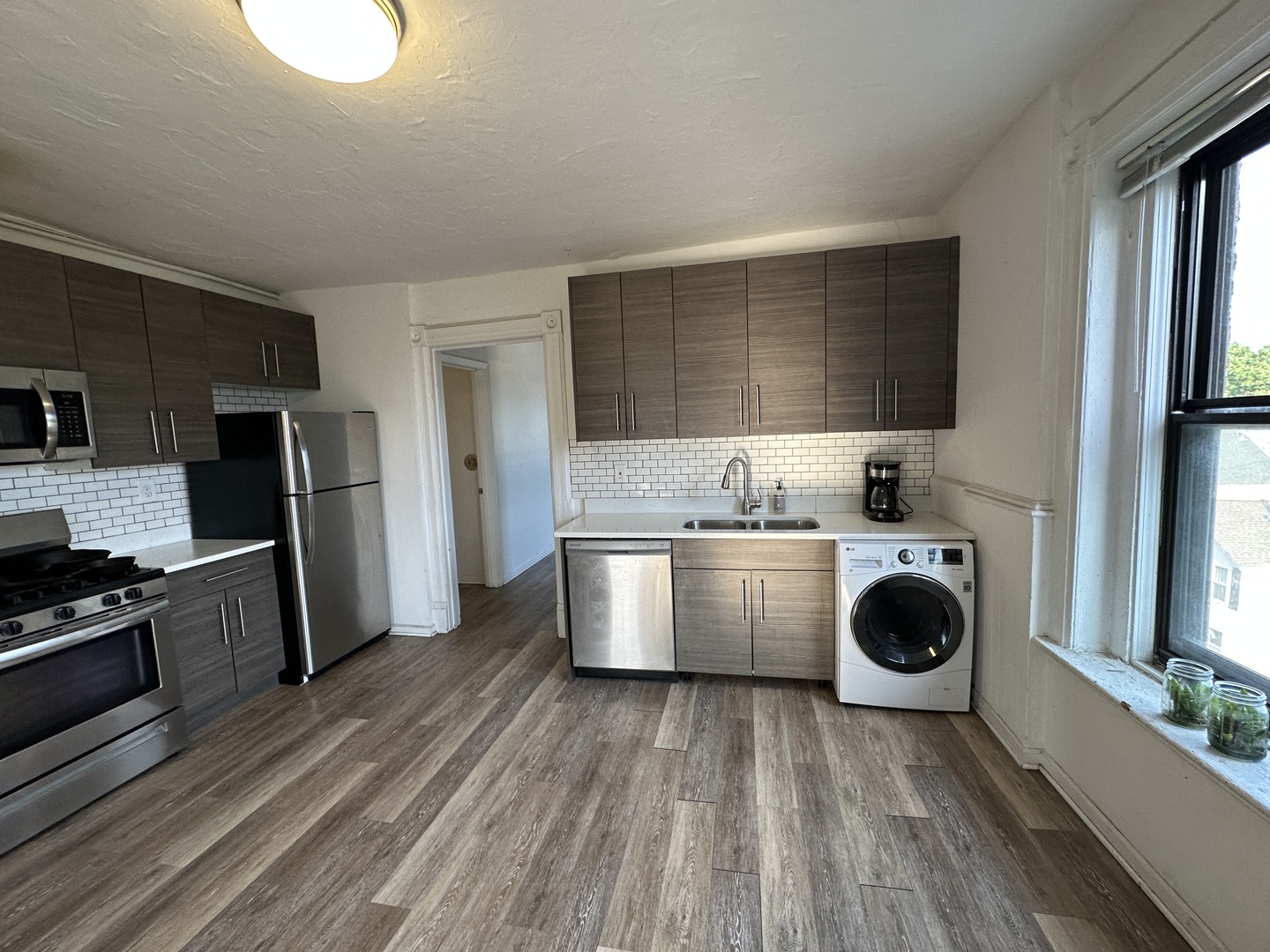 1237 North Noble Street, Unit 4 Chicago, IL 60642 - Photo 23 of 27 a kitchen with a refrigerator and a stove top oven
