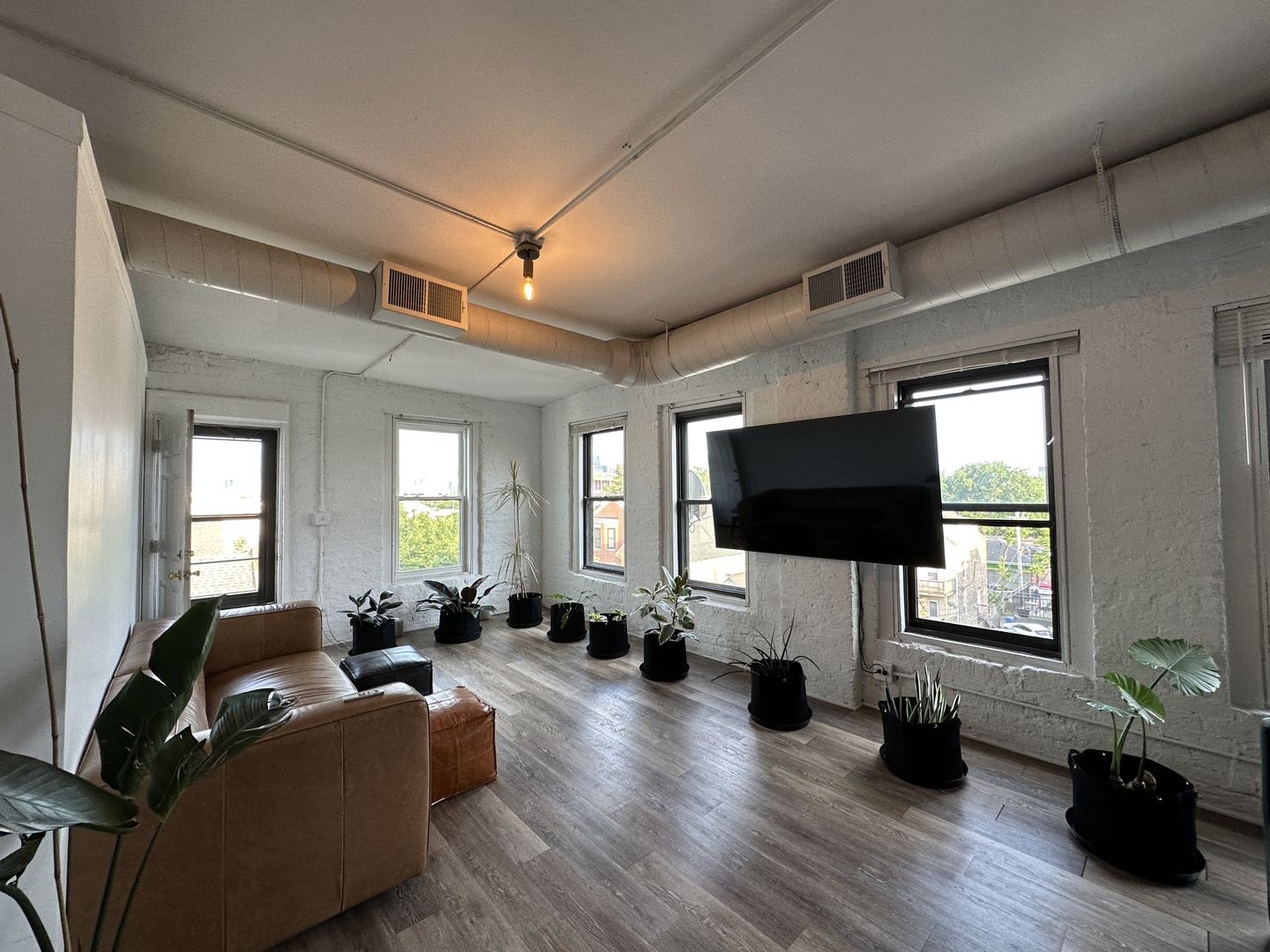 1237 North Noble Street, Unit 4 Chicago, IL 60642 - Photo 9 of 27 a living room with furniture and a flat screen tv