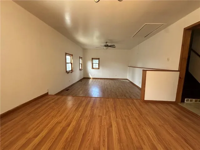 a view of a livingroom with wooden floor and a ceiling fan