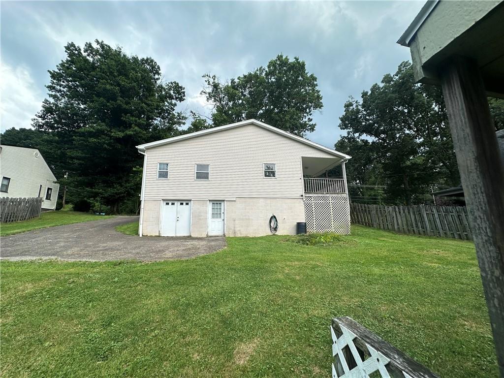 3323 Leechburg Road Lower Burrell, PA 15068 - Photo 9 of 42 a white house that has a small yard and trees in the background