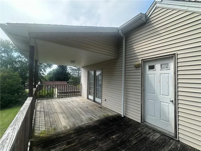 a view of a house with a tree in front of it