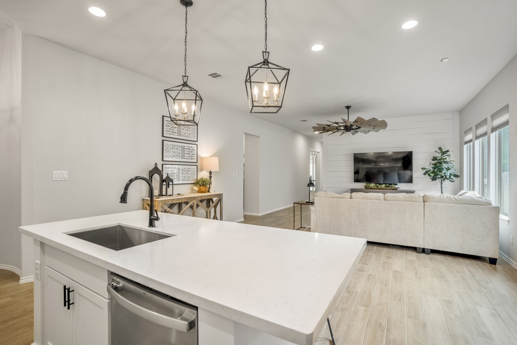 334 Topper Pines Drive Montgomery, TX 77316 - Photo 7 of 49 Standing in the kitchen is this amazing view showcasing the open-concept design that seamlessly connects the dining area and living room. This layout creates a spacious and inviting atmosphere for entertaining and daily life.